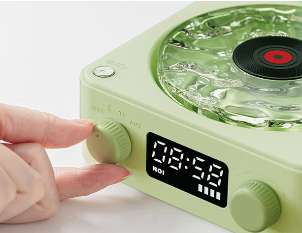 Retro Turntable Wireless Bluetooth Speaker showing a hand adjusting the volume on a vintage-inspired design.