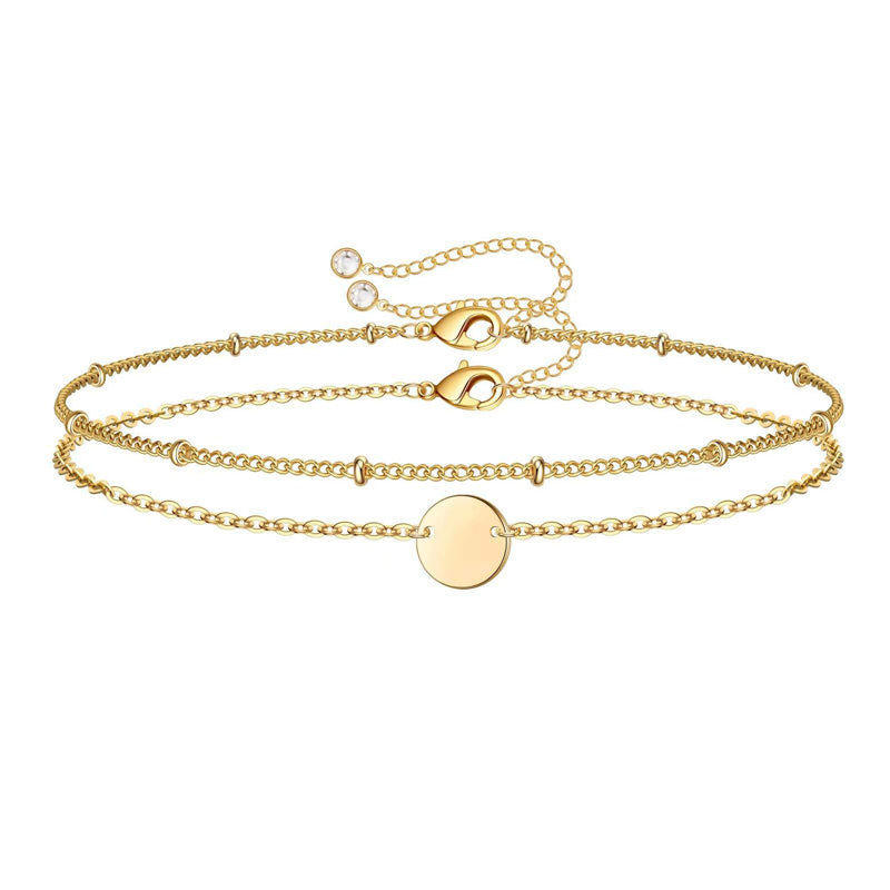 14K Gold Dainty Gold Bracelets featuring a stylish chain design with a round pendant.