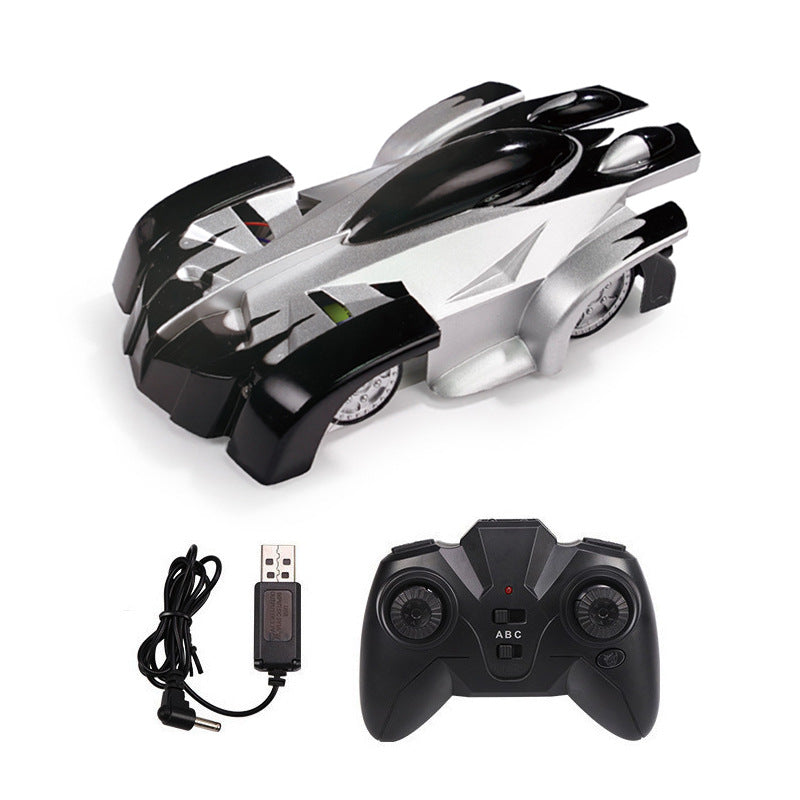 Wall climbing remote control car in black and silver with remote and charging cable.