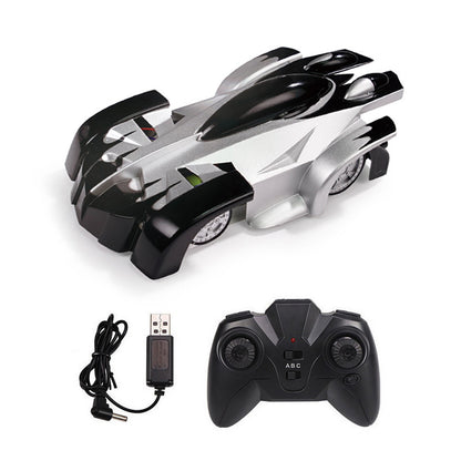 Wall climbing remote control car in black and silver with remote and charging cable.