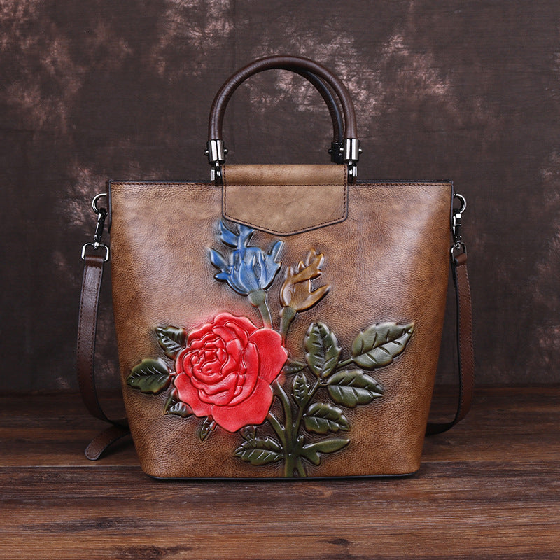 Vintage leather tote bag with floral design in brown and colorful roses, perfect for casual use.