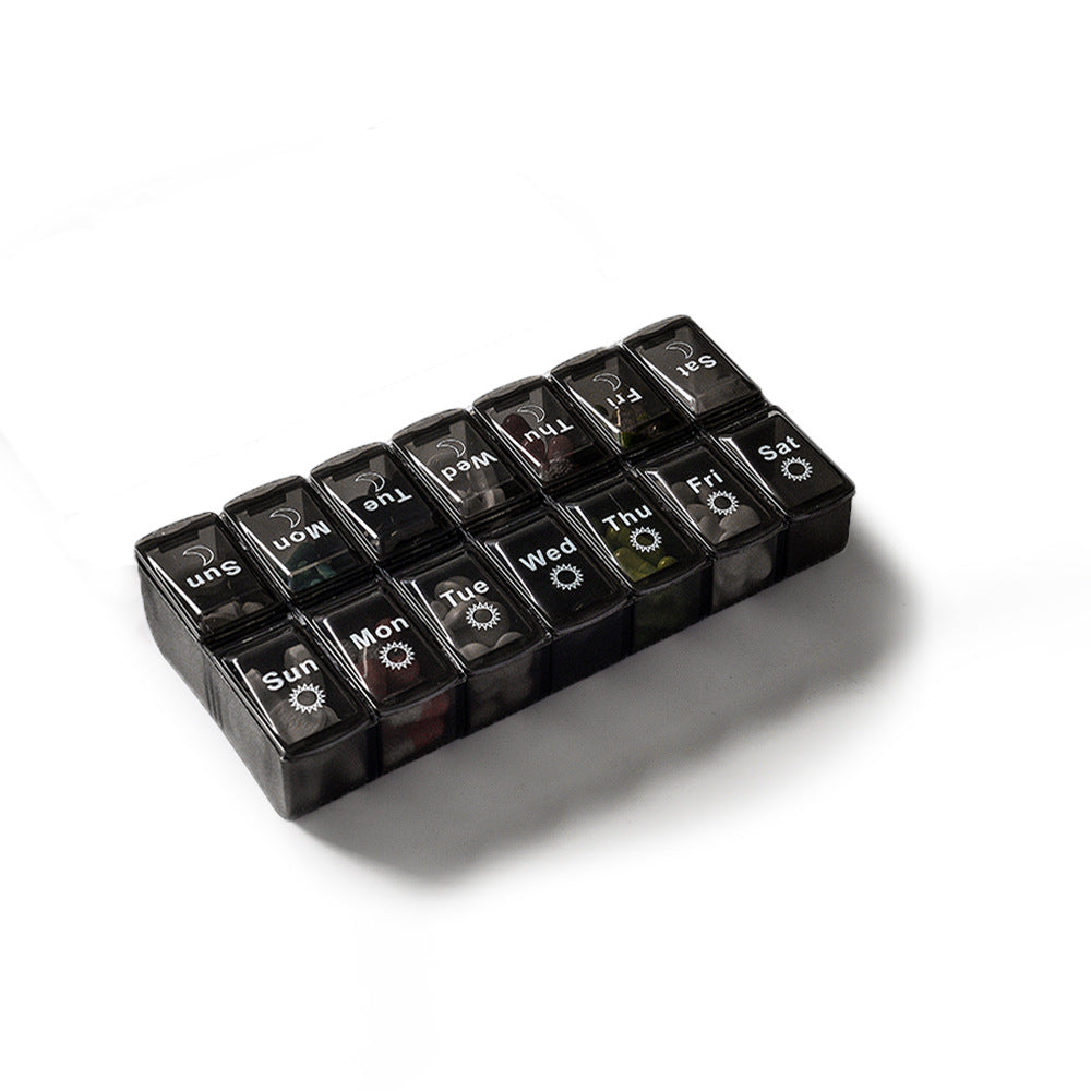 Black and white two-color large-capacity detachable pill box for storing seven-day pills.
