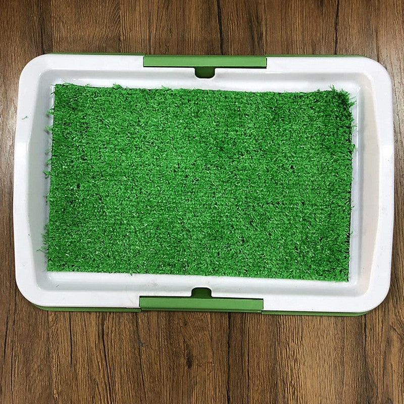 Splash proof puppy potty pad with synthetic grass surface for indoor pet training.