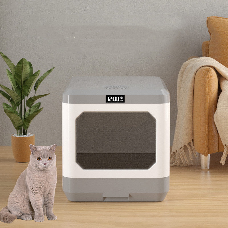 Fully enclosed cat litter basin drawer type with digital display and a cat beside it.