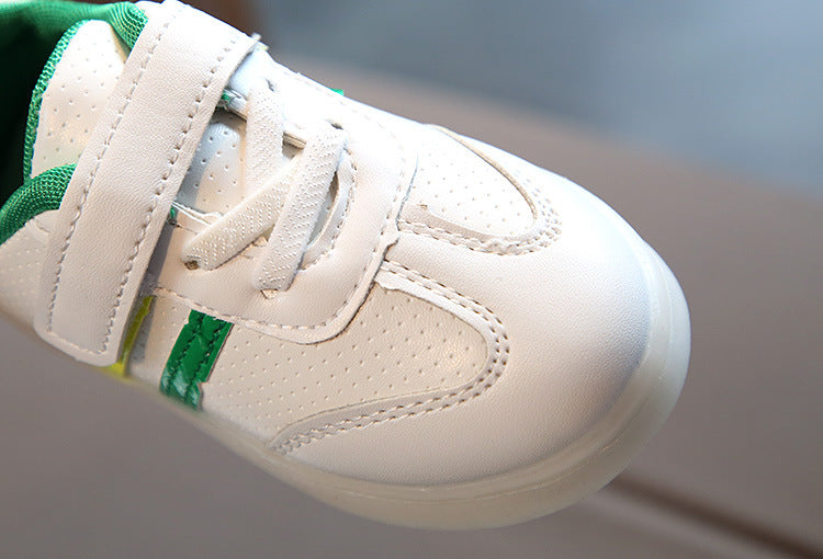 Kimmy White LED sneakers featuring a low upper design, Velcro straps, and vibrant green accents.