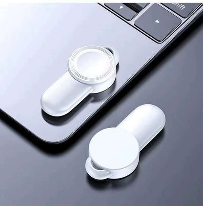 portable wireless charger for watch on a laptop surface, showcasing sleek design and wireless charging capability.
