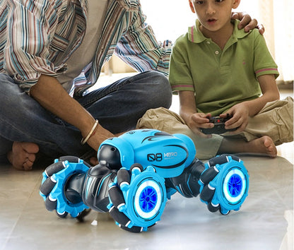 Boy playing with a gesture sensing remote control car in blue color, featuring bright LED lights and versatile wheels.