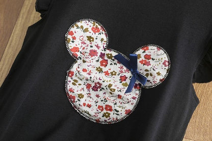 infant holiday girls dress featuring a floral Mickey Mouse patch on a black outfit for toddlers.