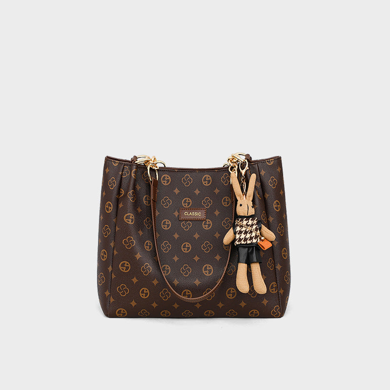 Stylish large-capacity women's commuter bag with a cute rabbit charm, crafted from synthetic leather.