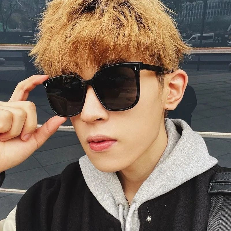 Mens And Womens Trendy Instagram-style Sunglasses worn by a young man with stylish hair and gray lenses.