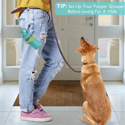 Portable dog pooper scooper with bag dispenser attached to jeans near a dog at home entrance.