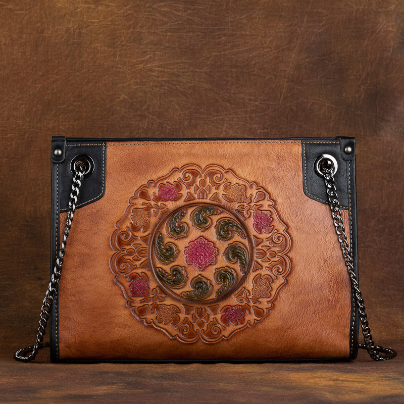 Large-capacity leather tote bag featuring embossed pattern, medium-soft genuine leather, and vintage design.