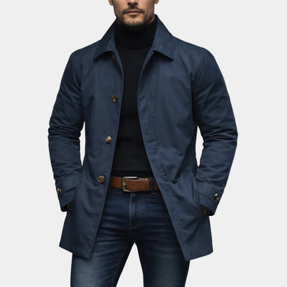 Mens retro waterproof cardigan coat modeled by a man wearing a black turtleneck and blue jeans.
