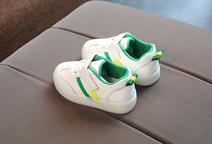 Kimmy White LED sneakers shoes in white with green and yellow accents on a gray surface.