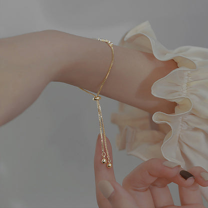 Versatile Japanese and Korean minimalist cat eye stone bracelet worn on wrist.