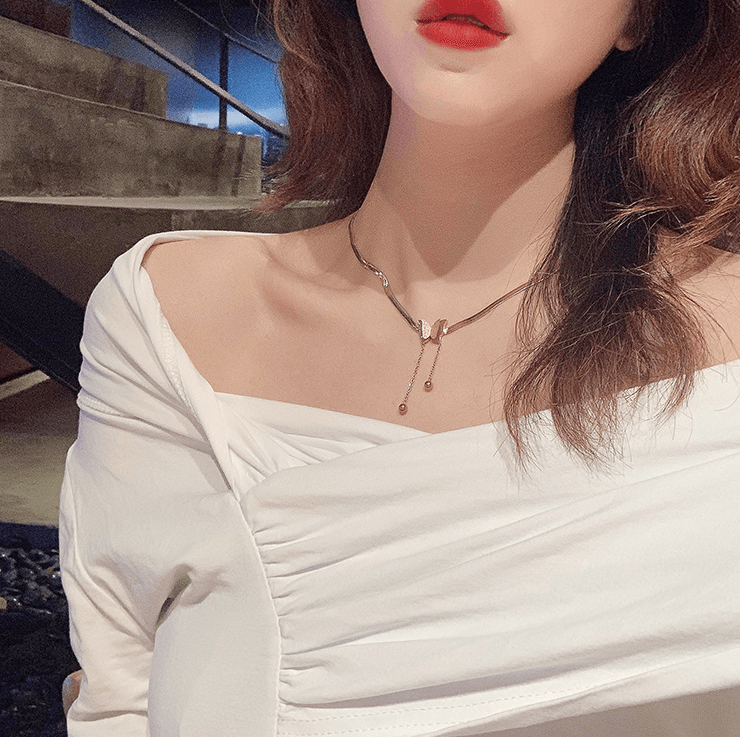 Butterfly Necklace worn by a woman with elegant makeup, showcasing its charm and sophistication.