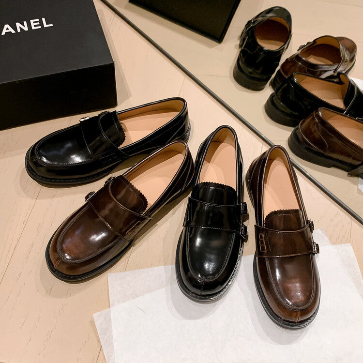 Retro distressed brown leather shoes displayed with black pair on a stylish surface.