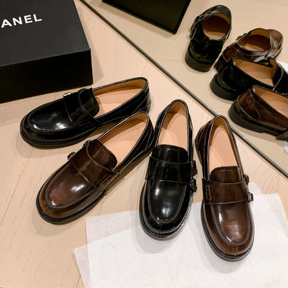 Retro distressed brown leather shoes displayed with black pair on a stylish surface.