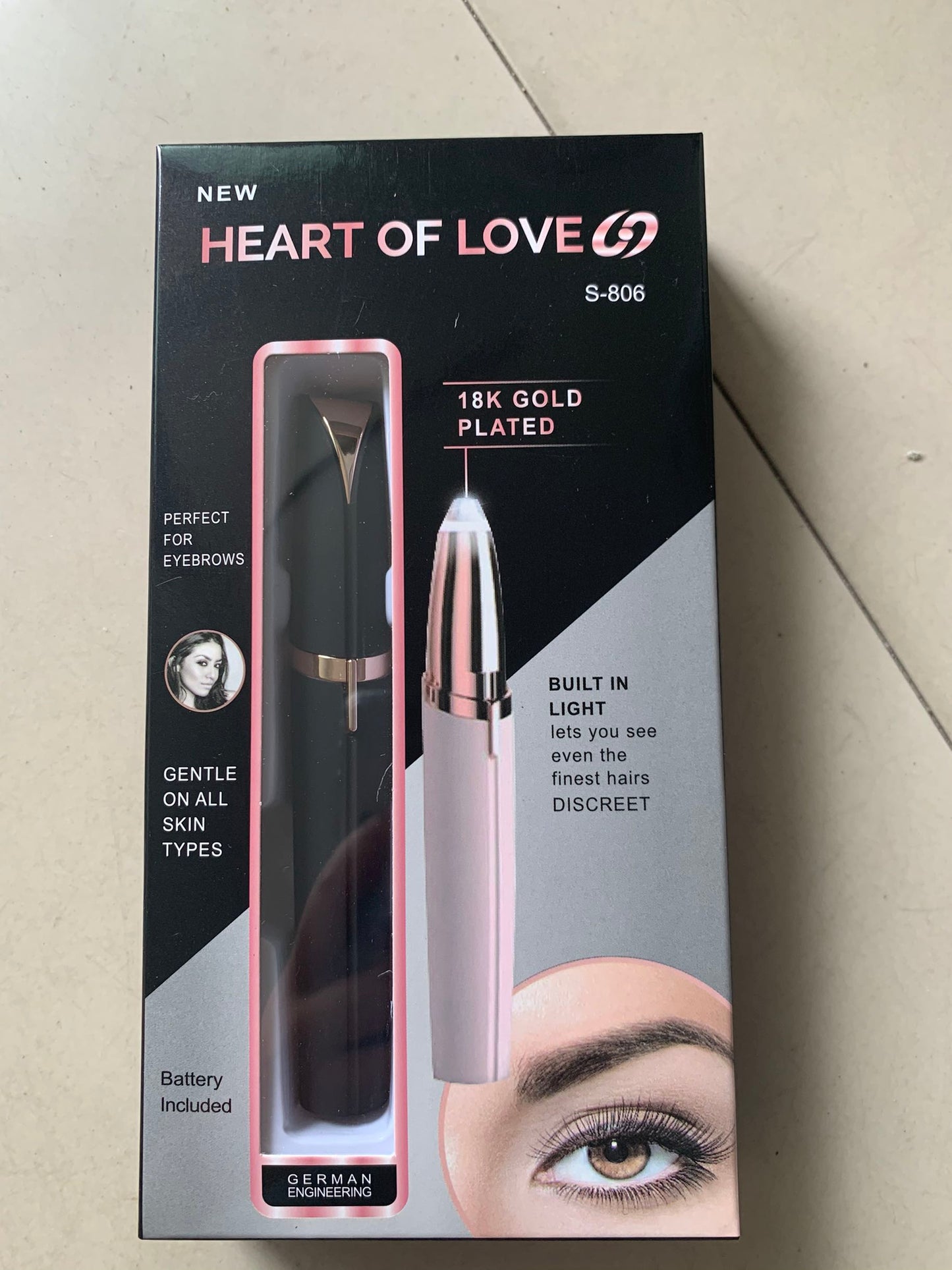 Flawlessly Brows Electric Eyebrow Remover in packaging, features 18k gold plated head and built-in light for easy use.