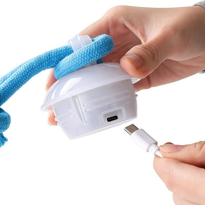 Close-up of The Chase Buddy toy showing touch activation feature and USB charging for smart dog boredom toy.