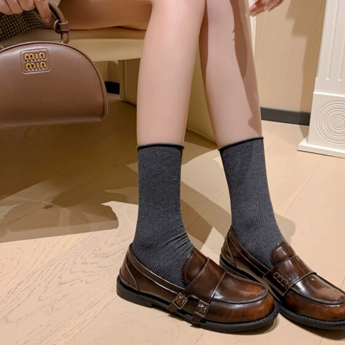 Retro distressed brown leather shoes paired with gray socks for a trendy casual look.