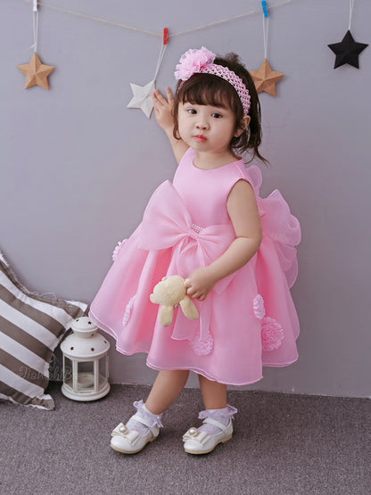 Cute toddler in a pink princess dress for girls holding a stuffed toy, perfect for spring and summer celebrations.