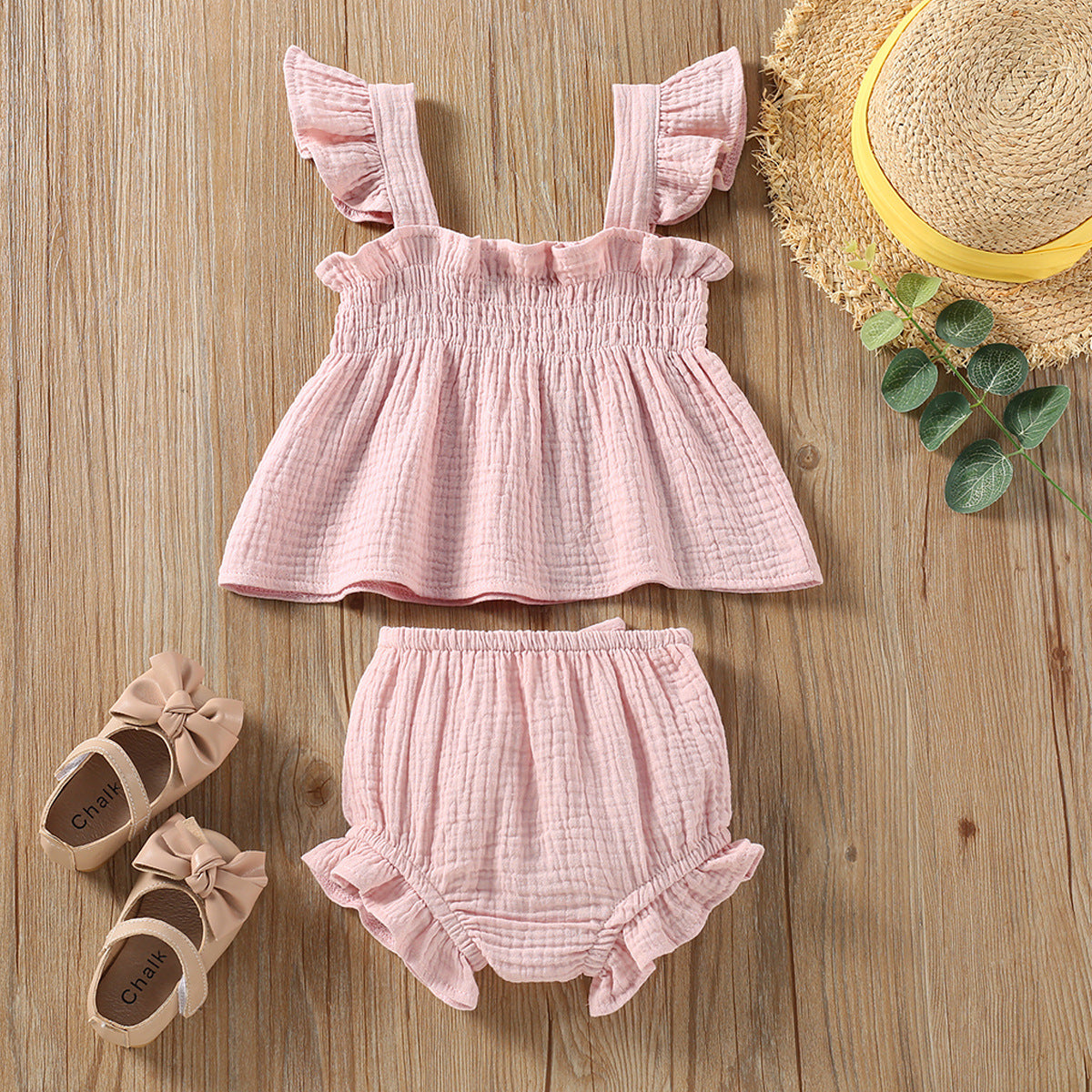 Girls solid color sling top shorts set in pink with ruffled straps and matching shorts.