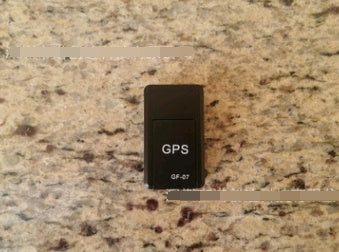 Anti-lost tracking alarm GPS device GF-07 on a granite surface.