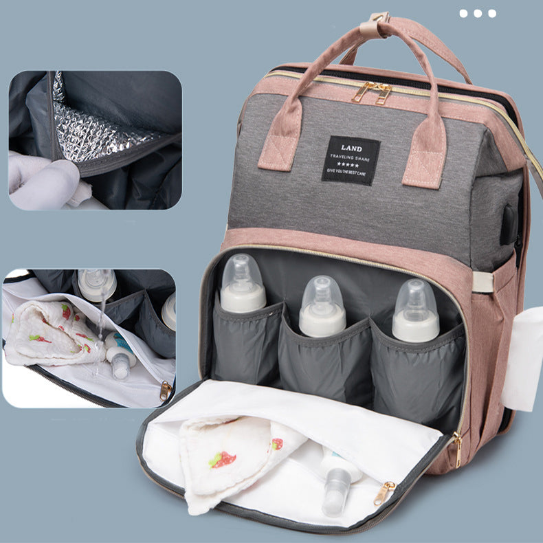 Large capacity mummy baby backpack showcasing insulated bottle pockets and organized compartments.