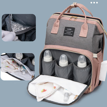 Large capacity mummy baby backpack showcasing insulated bottle pockets and organized compartments.