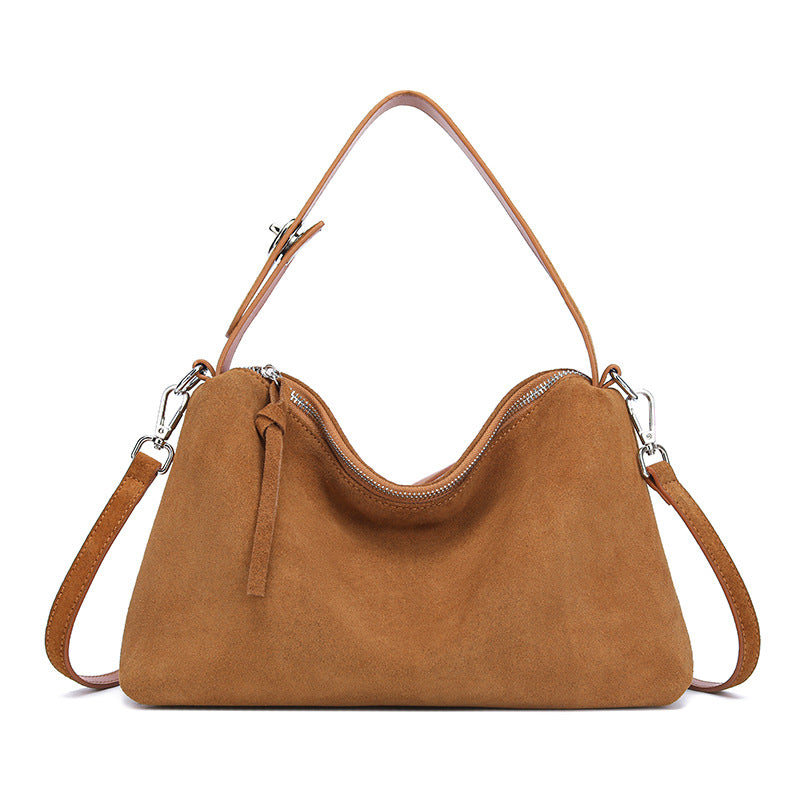 Genuine suede leather tote bag in caramel color with dual shoulder straps and a zip closure.