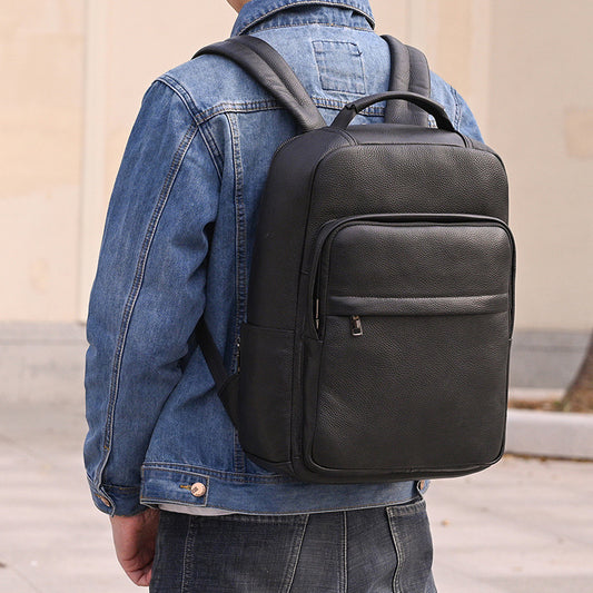 Men wearing a genuine leather commuter backpack in solid black, showcasing a stylish and trendy design.