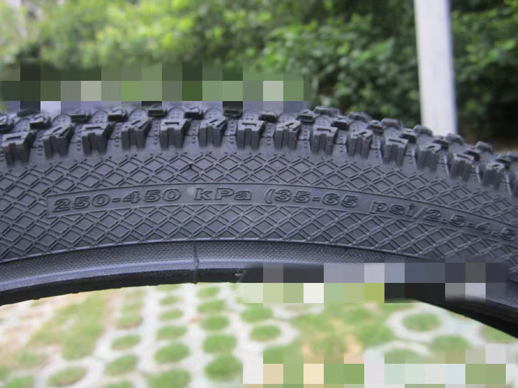 ultralight puncture proof mountain bike tire with pressure ratings 35-65 psi and tread detail.
