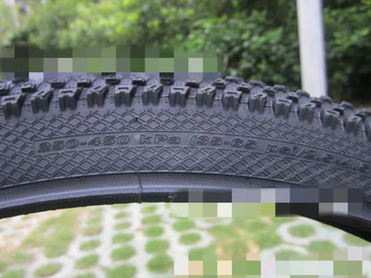 ultralight puncture proof mountain bike tire with pressure ratings 35-65 psi and tread detail.