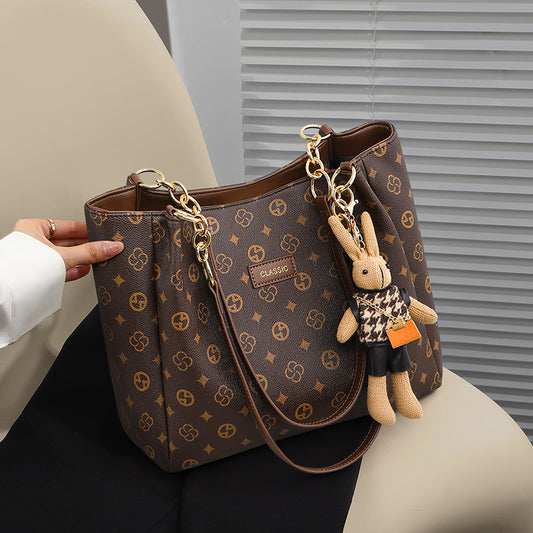large-capacity women's commuter bag with decorative bunny keychain and stylish design
