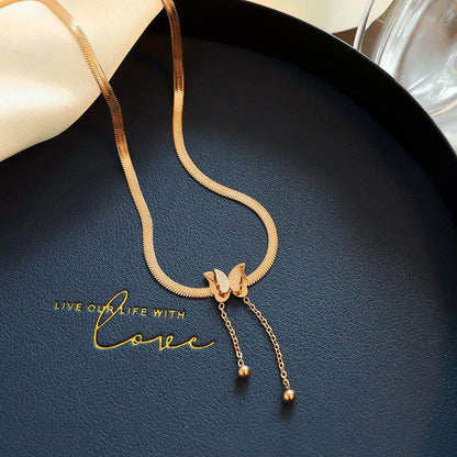 Butterfly Necklace featuring a delicate butterfly pendant on a gold chain, perfect for elegant outfits.