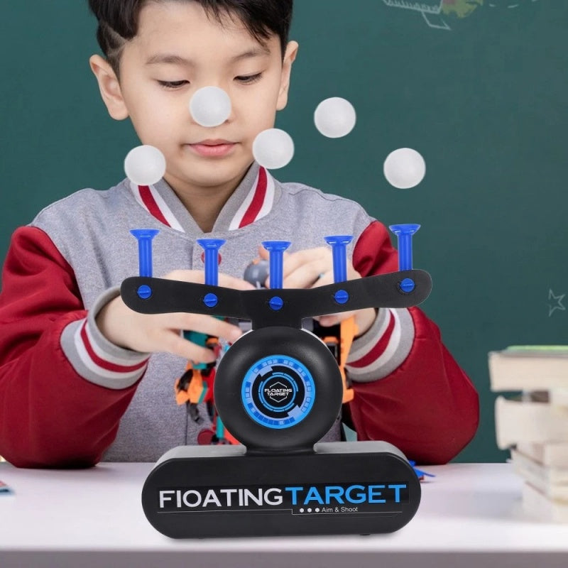 Child playing with levitating flyball target toy, aiming at floating balls in educational game.