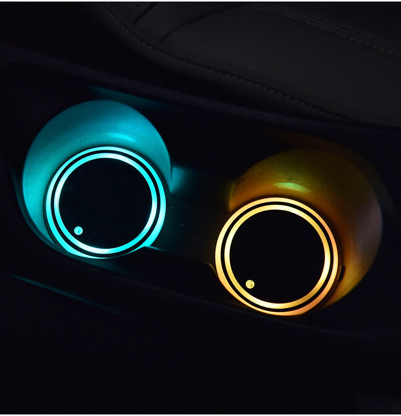 LED light-up car coaster glowing in different colors in a car's cup holder.