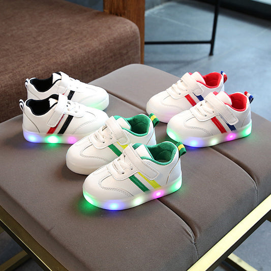 Kimmy White LED sneakers displayed in various colors on a stylish table, showcasing their fun light-up soles.