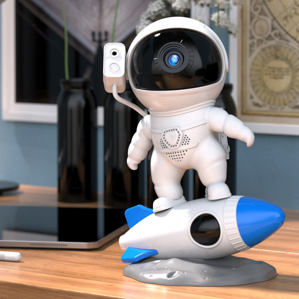 Rocket astronaut projector lamp on a desk, featuring an astronaut and rocket design, perfect for a starry sky ambiance.