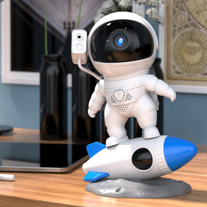 Rocket astronaut projector lamp on a desk, featuring an astronaut and rocket design, perfect for a starry sky ambiance.