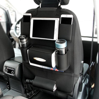 Leather car seat organizer with multiple pockets for tablets, drinks, and personal items in a vehicle.