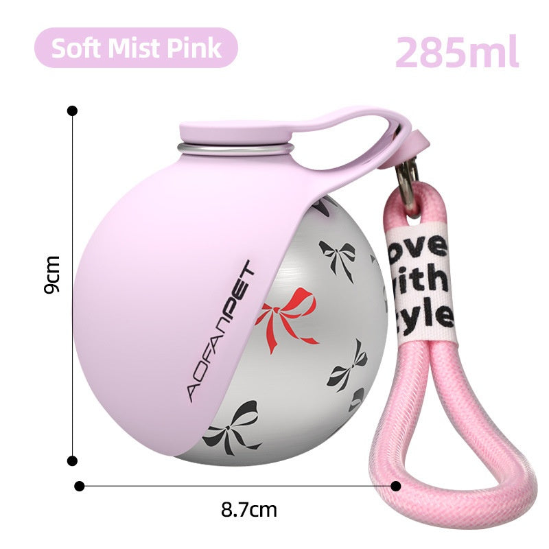 Portable dog water bottle in soft mist pink with a convenient carrying strap, ideal for pet hydration on the go.