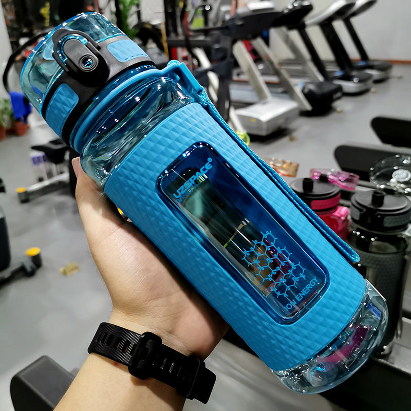 Portable sport water bottle in blue held in hand, ideal for sports use and high-temperature resilience.