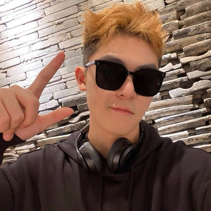 Mens And Womens Trendy Instagram-style Sunglasses worn by a person with short hair, black hoodie, and headphones.