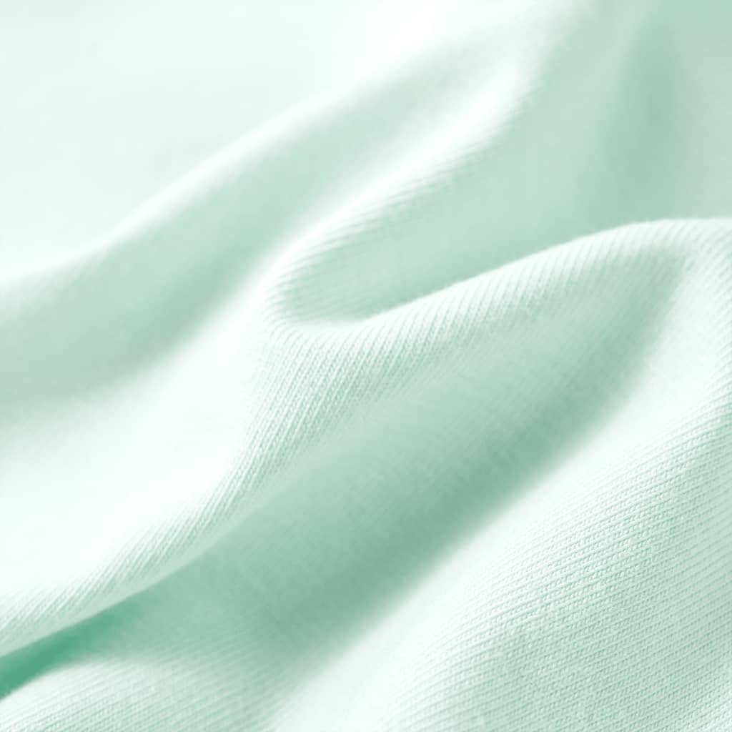 light mint green children's t-shirt fabric texture close-up showing softness and quality.