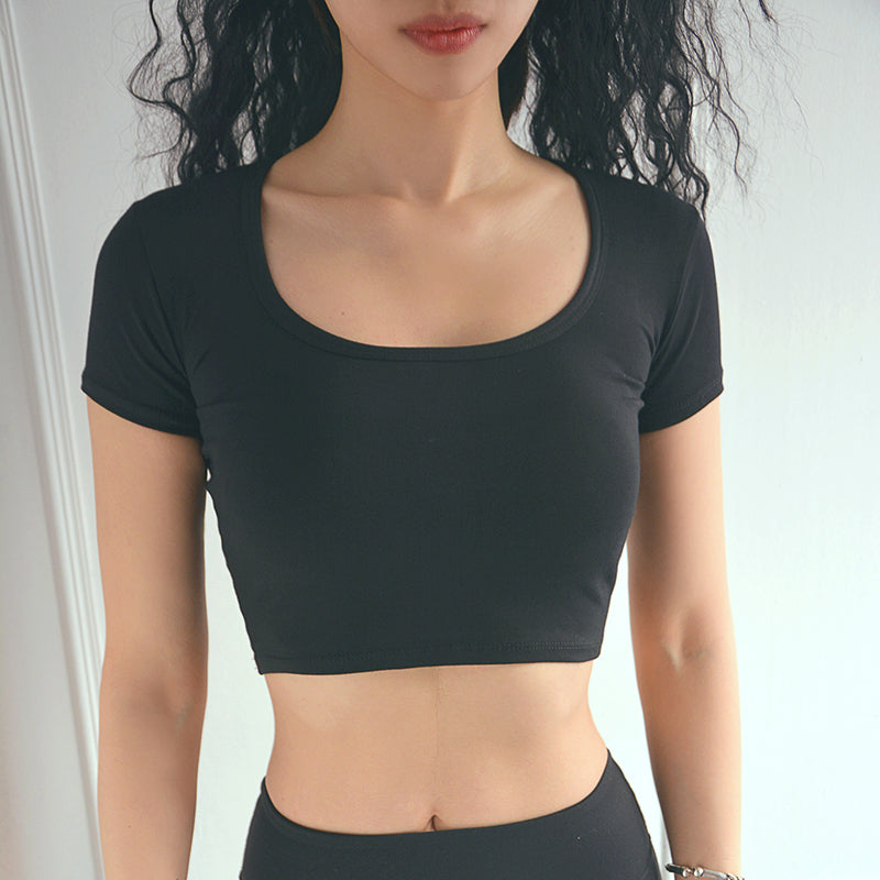 Black sports short sleeve vest displayed on a model, showcasing its cropped design and fitted style.