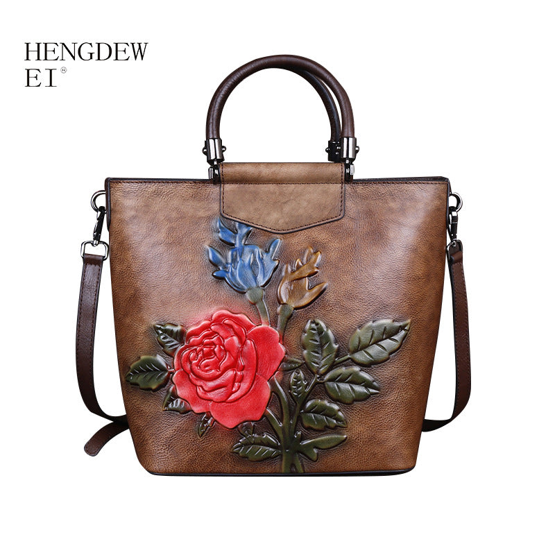 Vintage leather tote bag with floral design in red and blue, made from genuine leather, perfect for casual use.