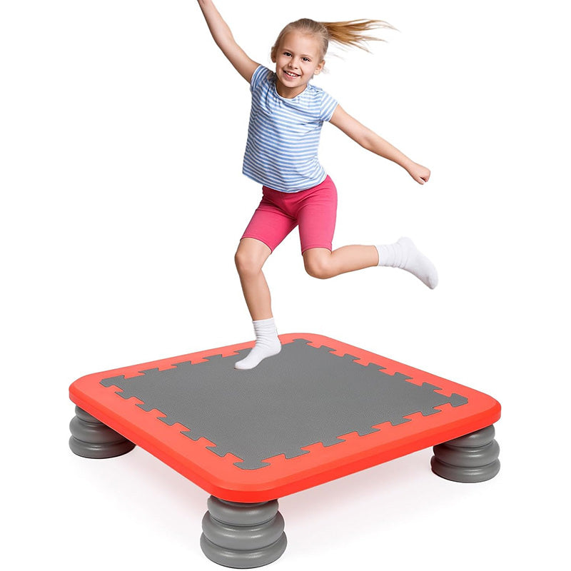 Young girl jumping on a MagicMeadow sensory trampoline board for kids in a compact design.