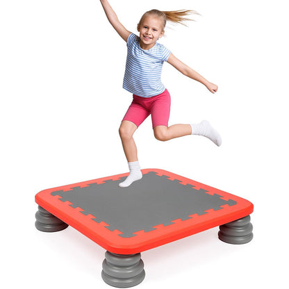 Young girl jumping on a MagicMeadow sensory trampoline board for kids in a compact design.